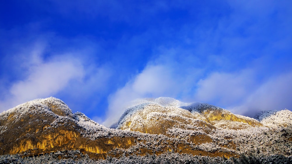 a mountain covered in snow under a blue sky