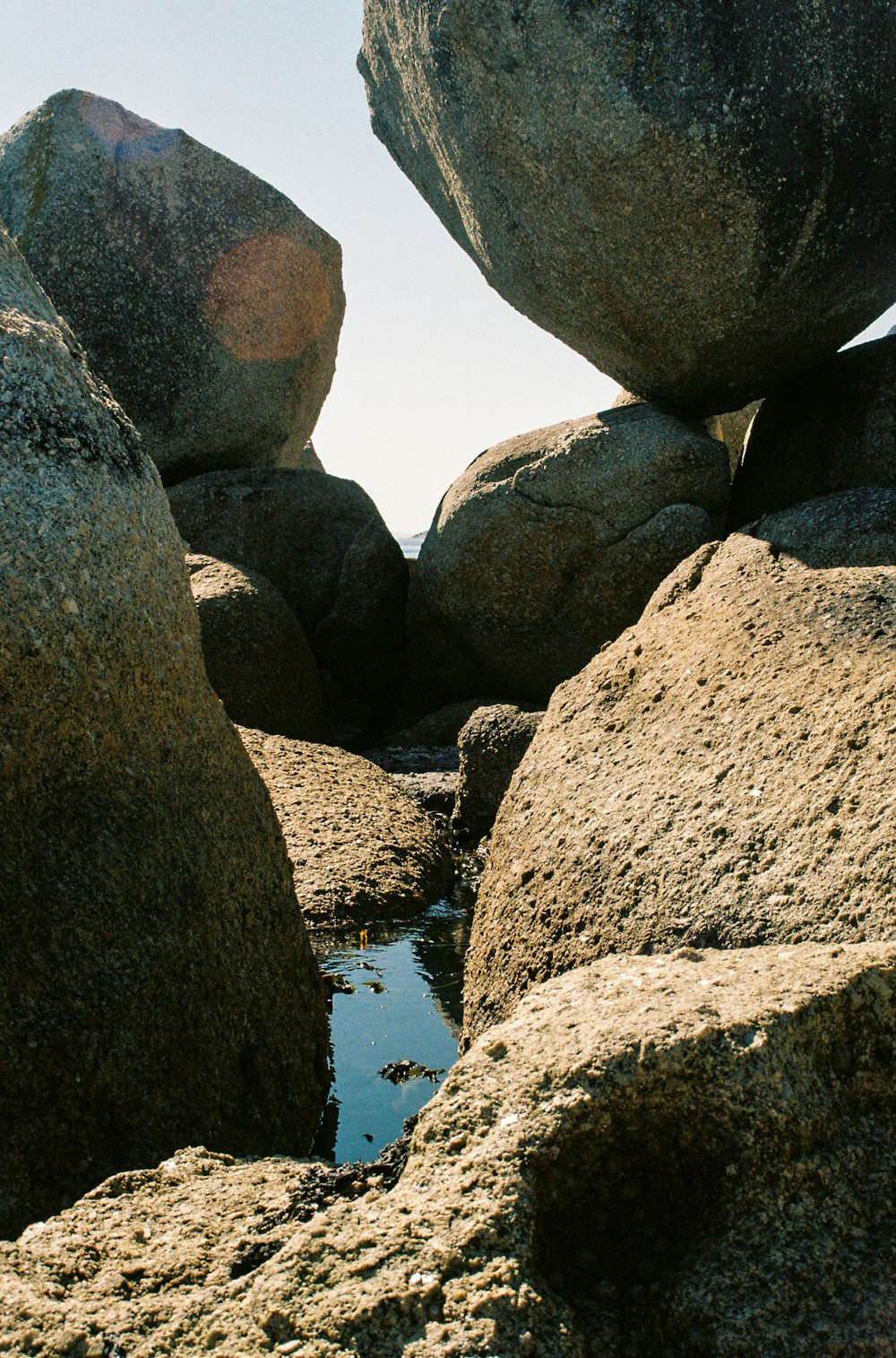 a rock formation with water in the middle of it