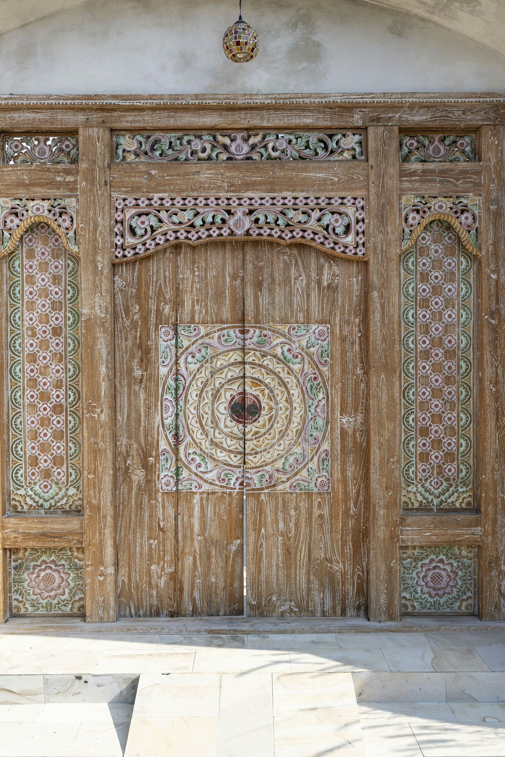 a large wooden door with intricate designs on it