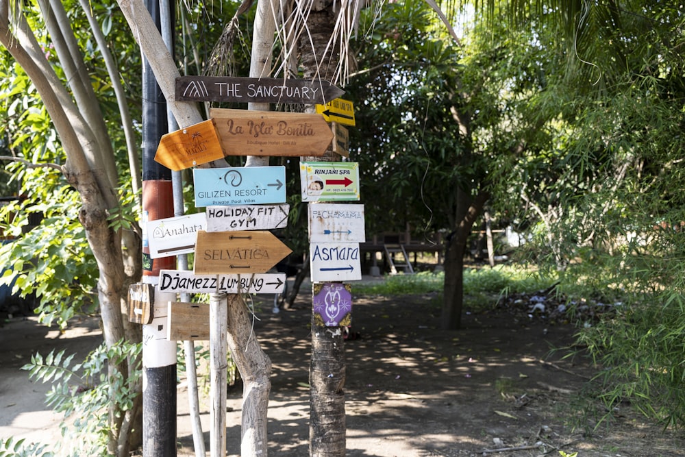 a bunch of signs that are on a pole