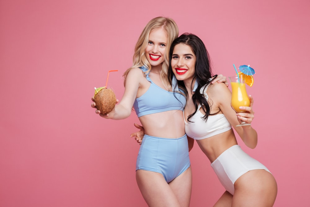 two beautiful women in bikinis posing for a picture