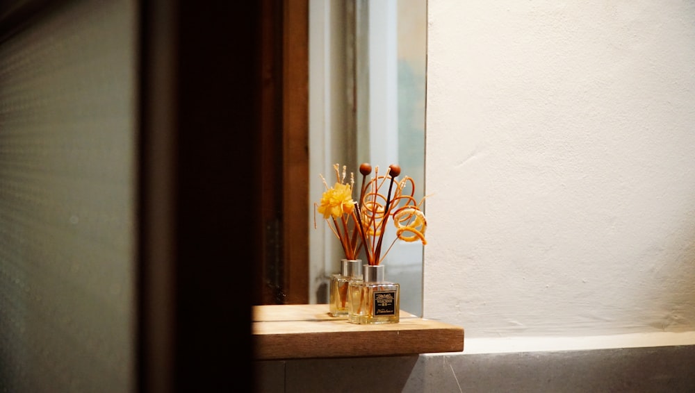 a window sill with a vase of flowers on top of it