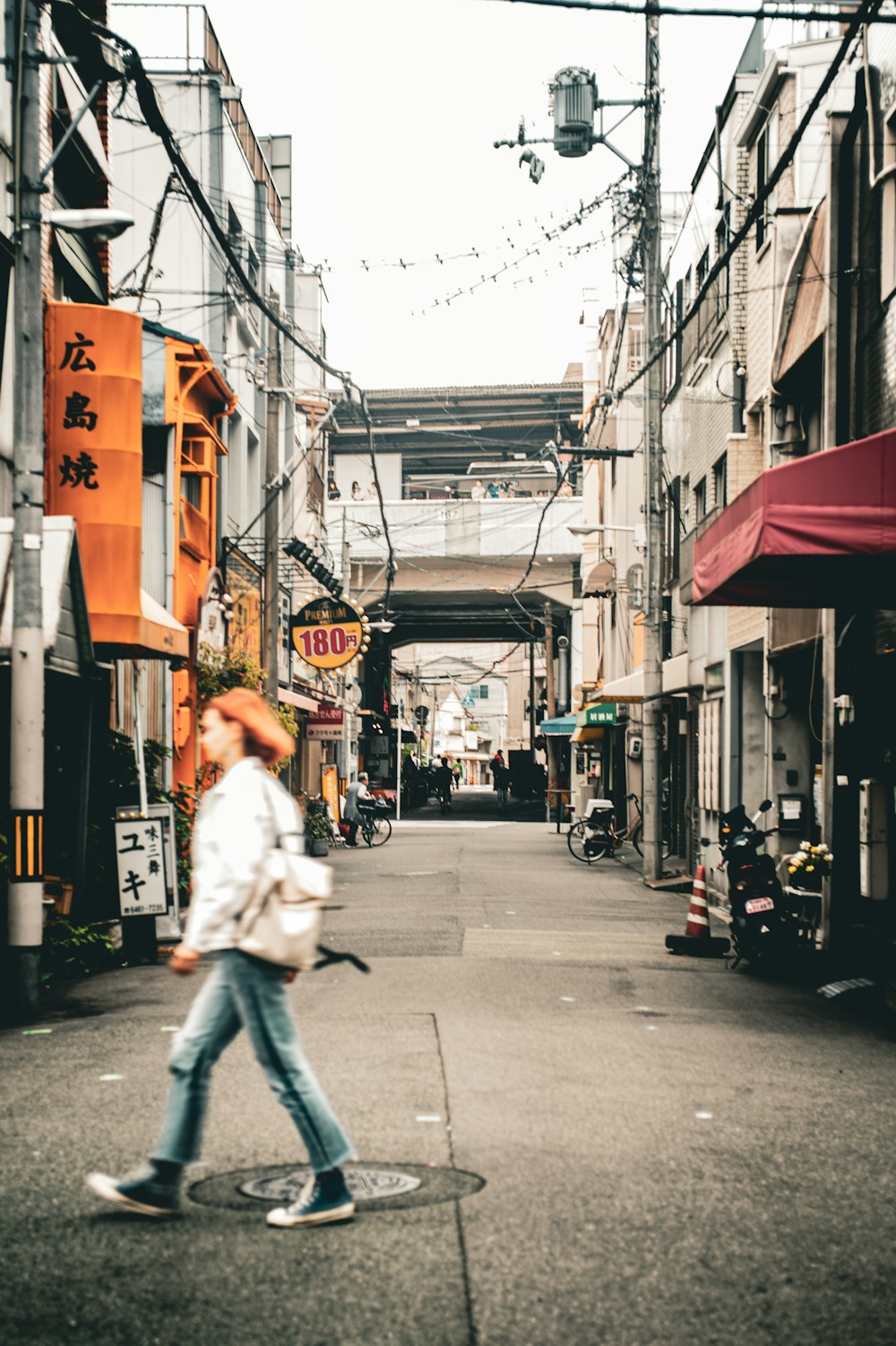 a man riding a skateboard down a street next to tall buildings