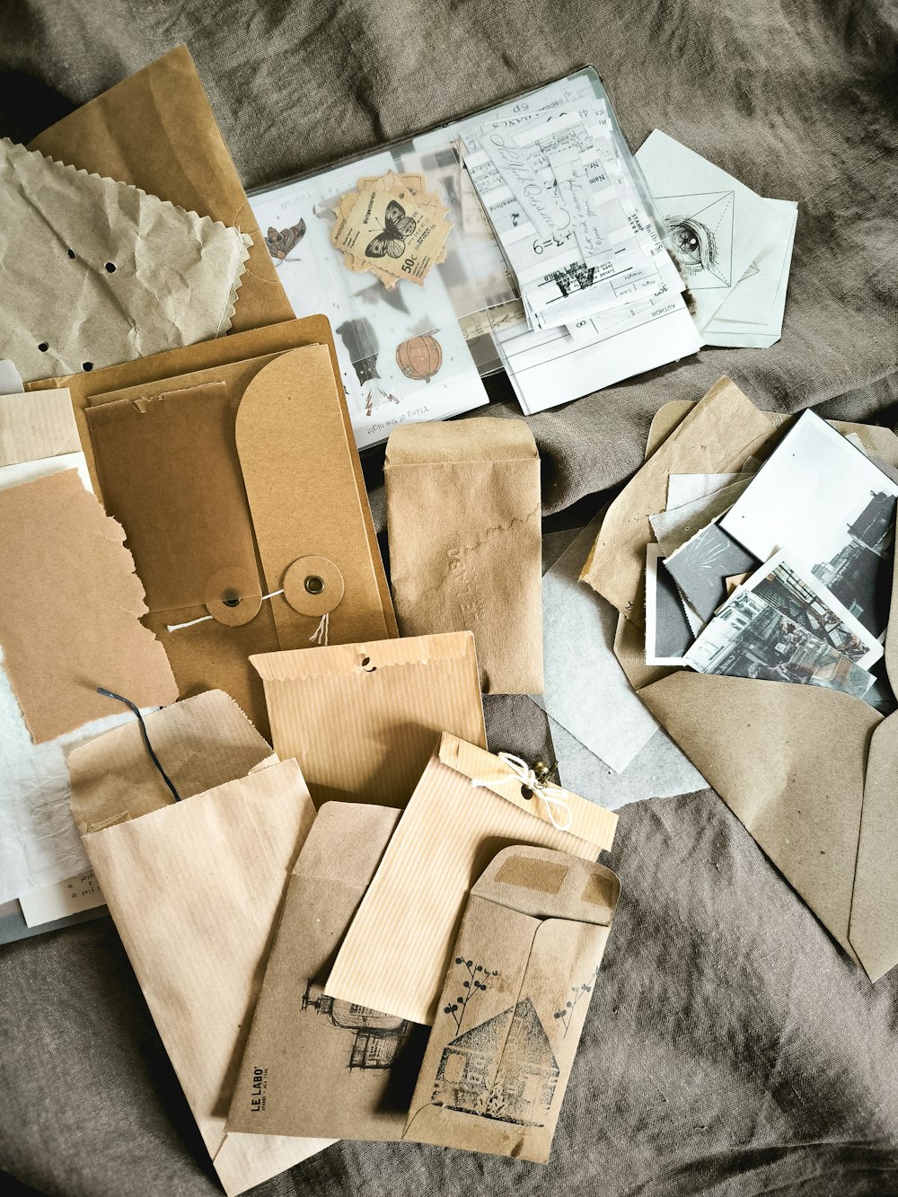 a pile of old envelopes sitting on top of a bed