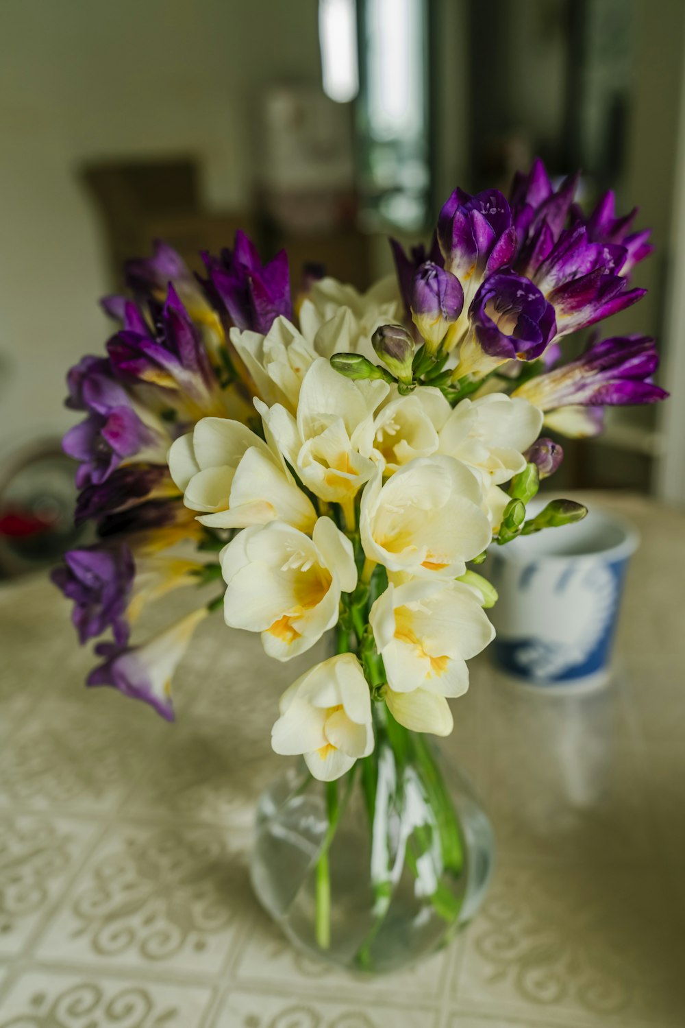 a vase filled with purple and white flowers