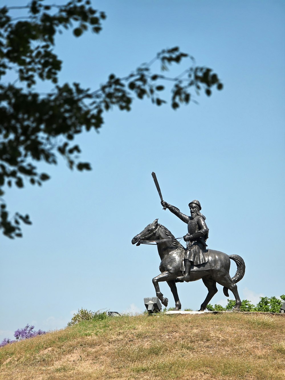 a statue of a man on a horse holding a sword