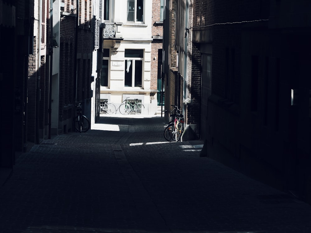 a narrow alley way with a bicycle parked on the side