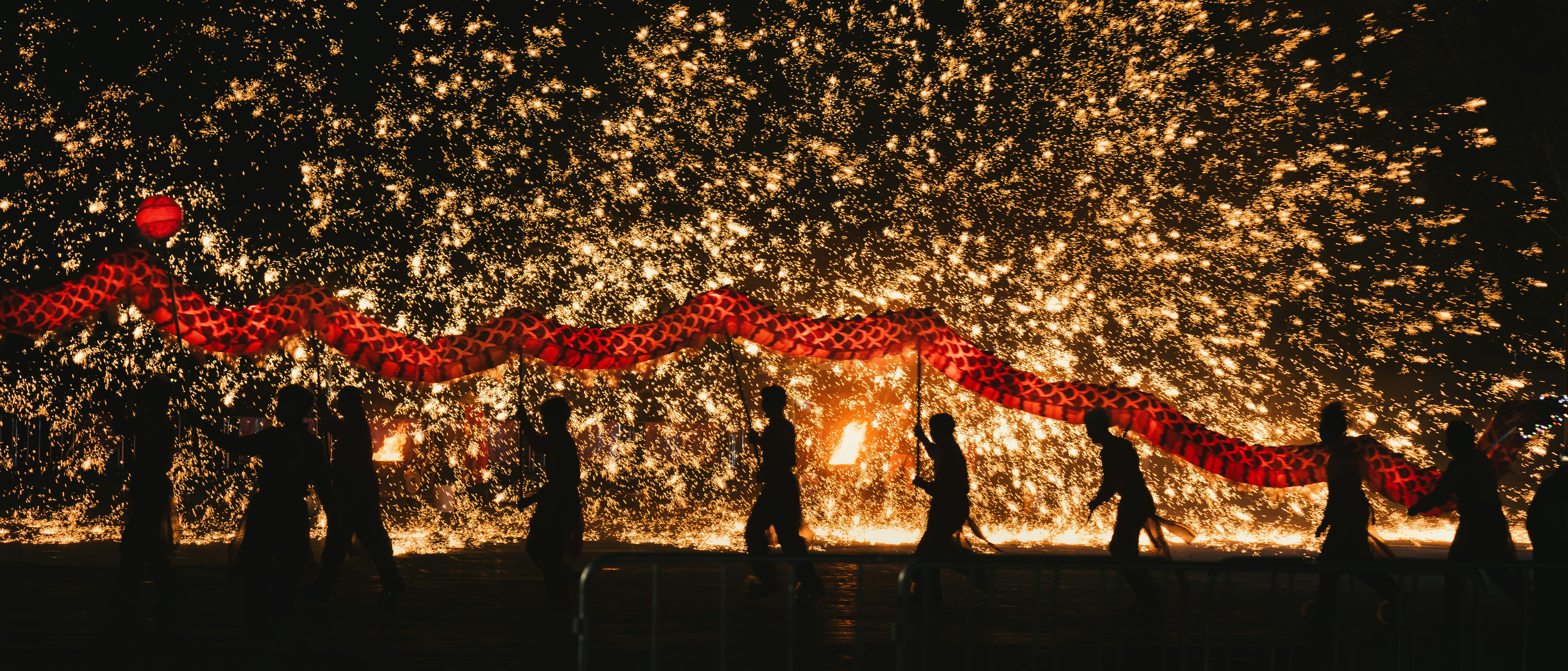 a group of people standing in front of a fire