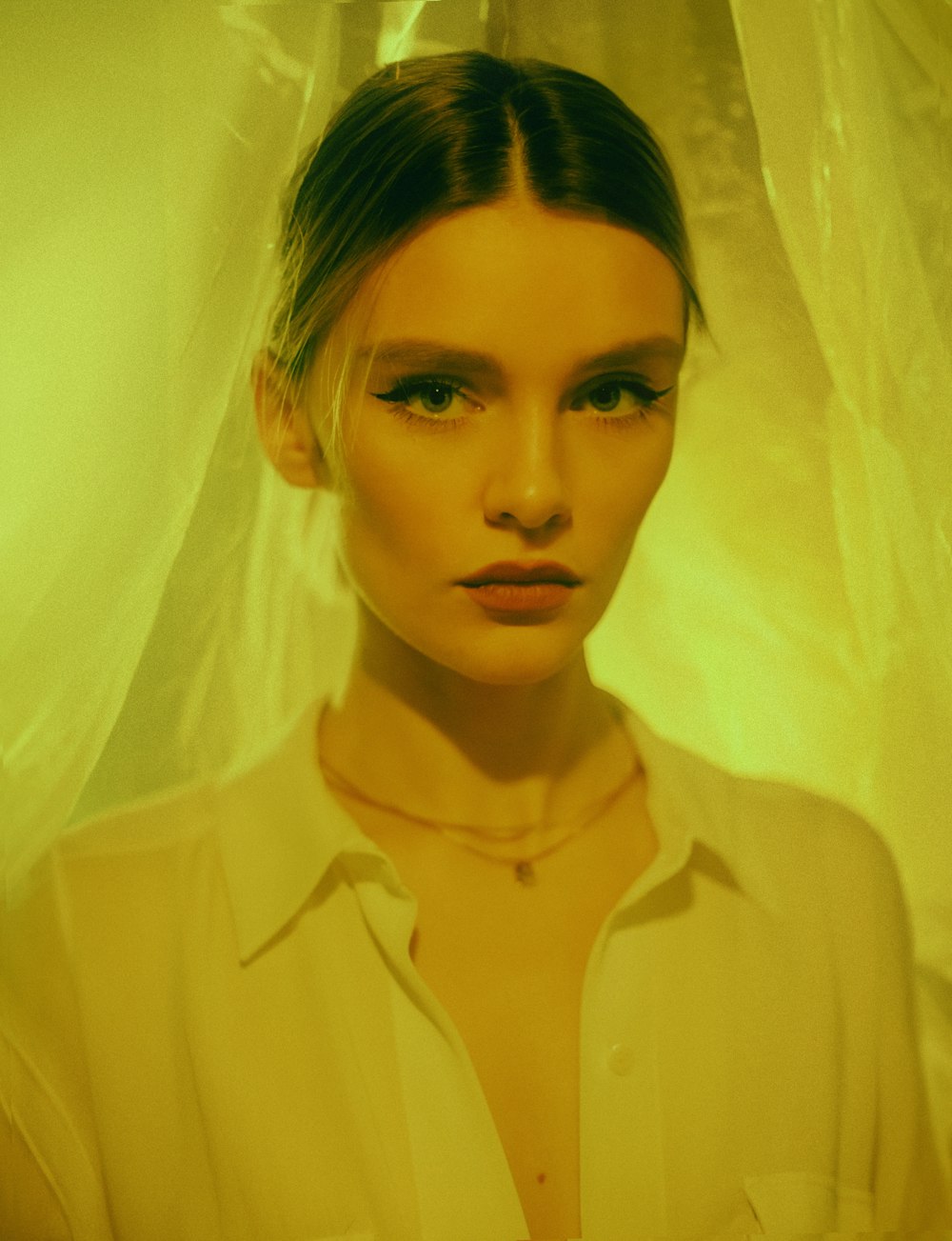 a woman standing in front of a white curtain