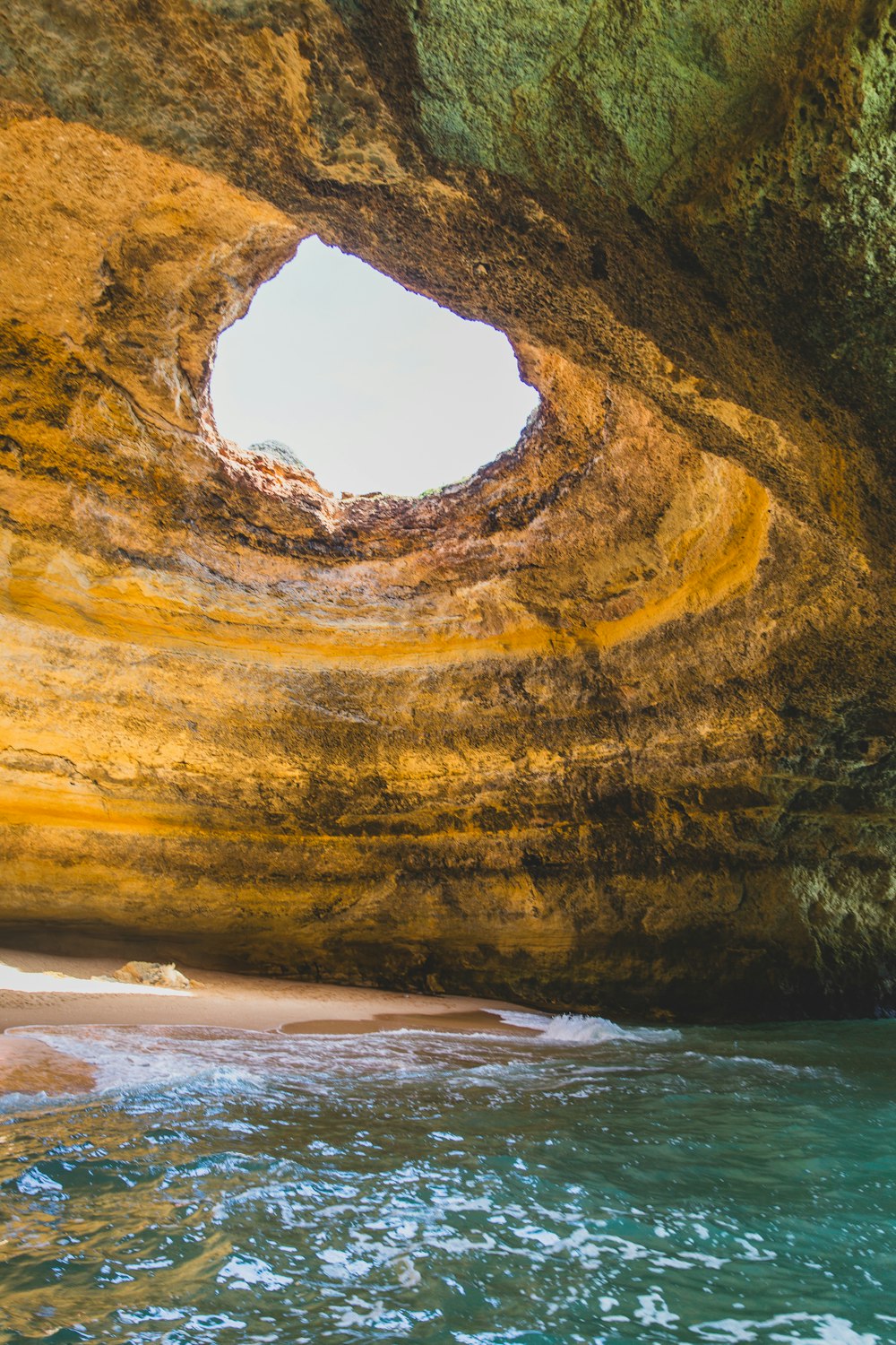 a view of the inside of a cave from the water