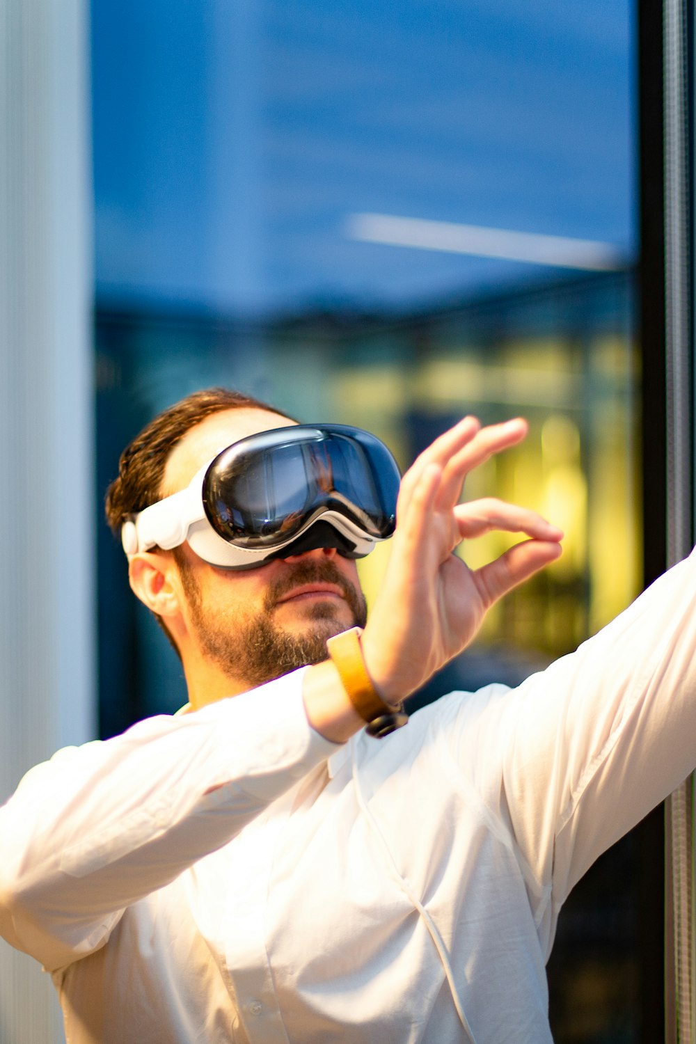 a man in a white shirt wearing a pair of goggles