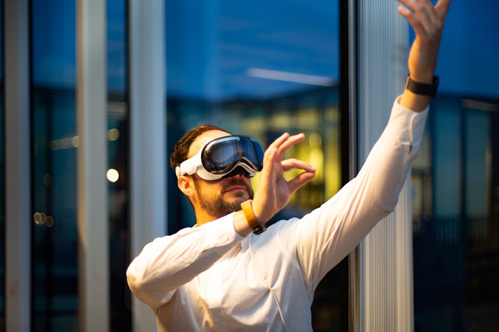 a man in a white shirt wearing a pair of virtual glasses