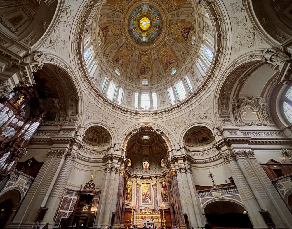 a church with a high vaulted ceiling and stained glass windows