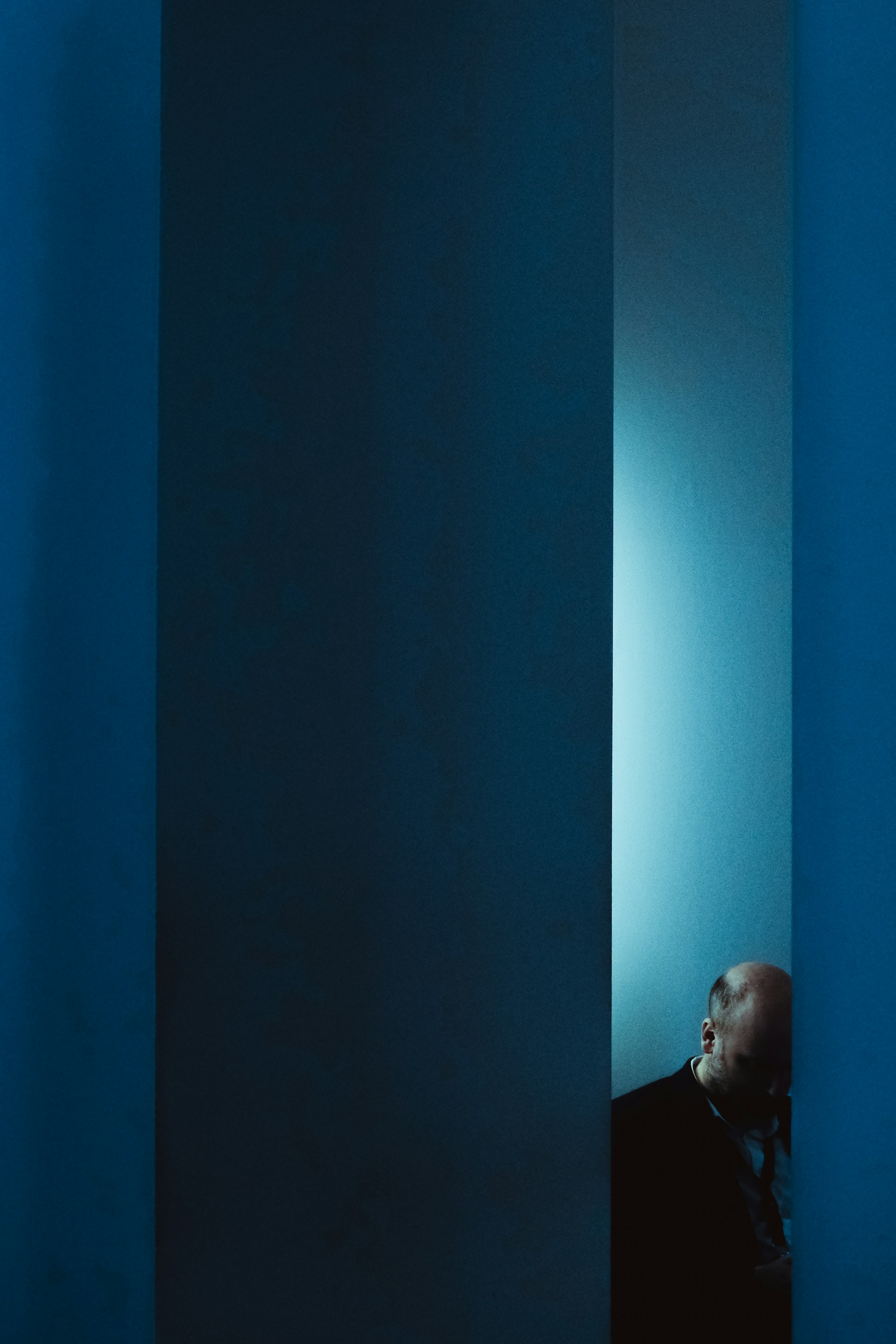 a man standing in a corner of a room