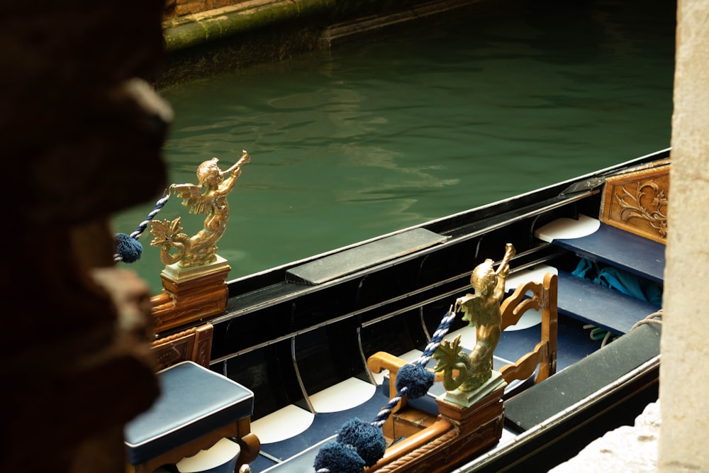 a gondola with a statue of a man on it