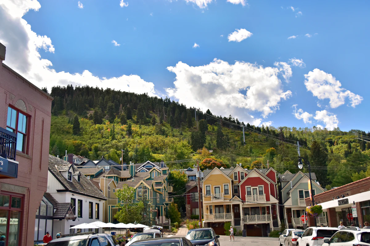 Colorful Park City buildings below a wooded hillside in Utah