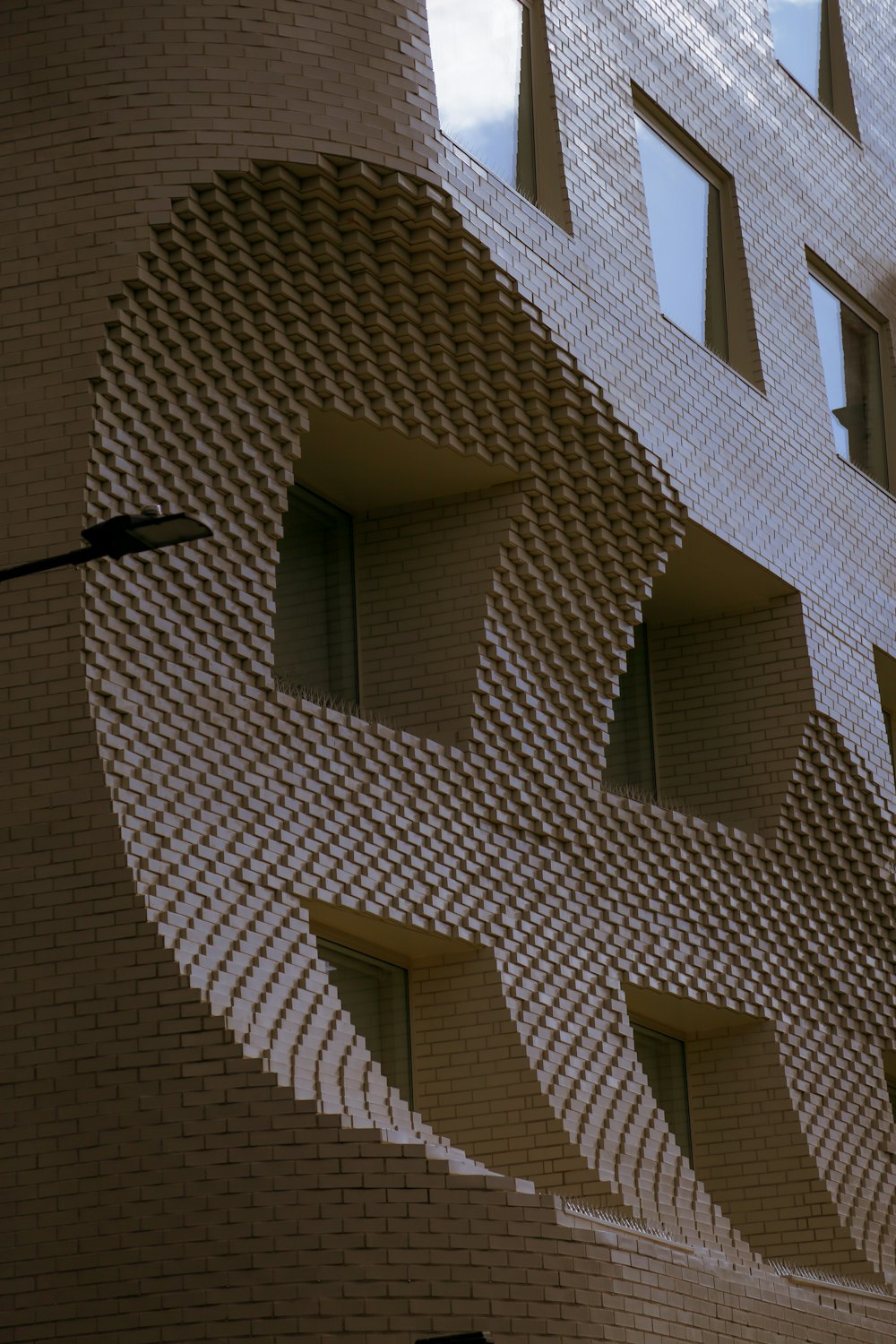 a building made out of bricks with a bird flying in front of it