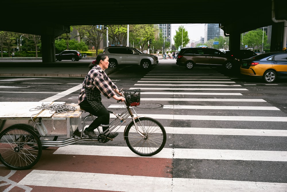 a man riding a bike across a cross walk