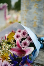 a bouquet of flowers is wrapped in a blue paper