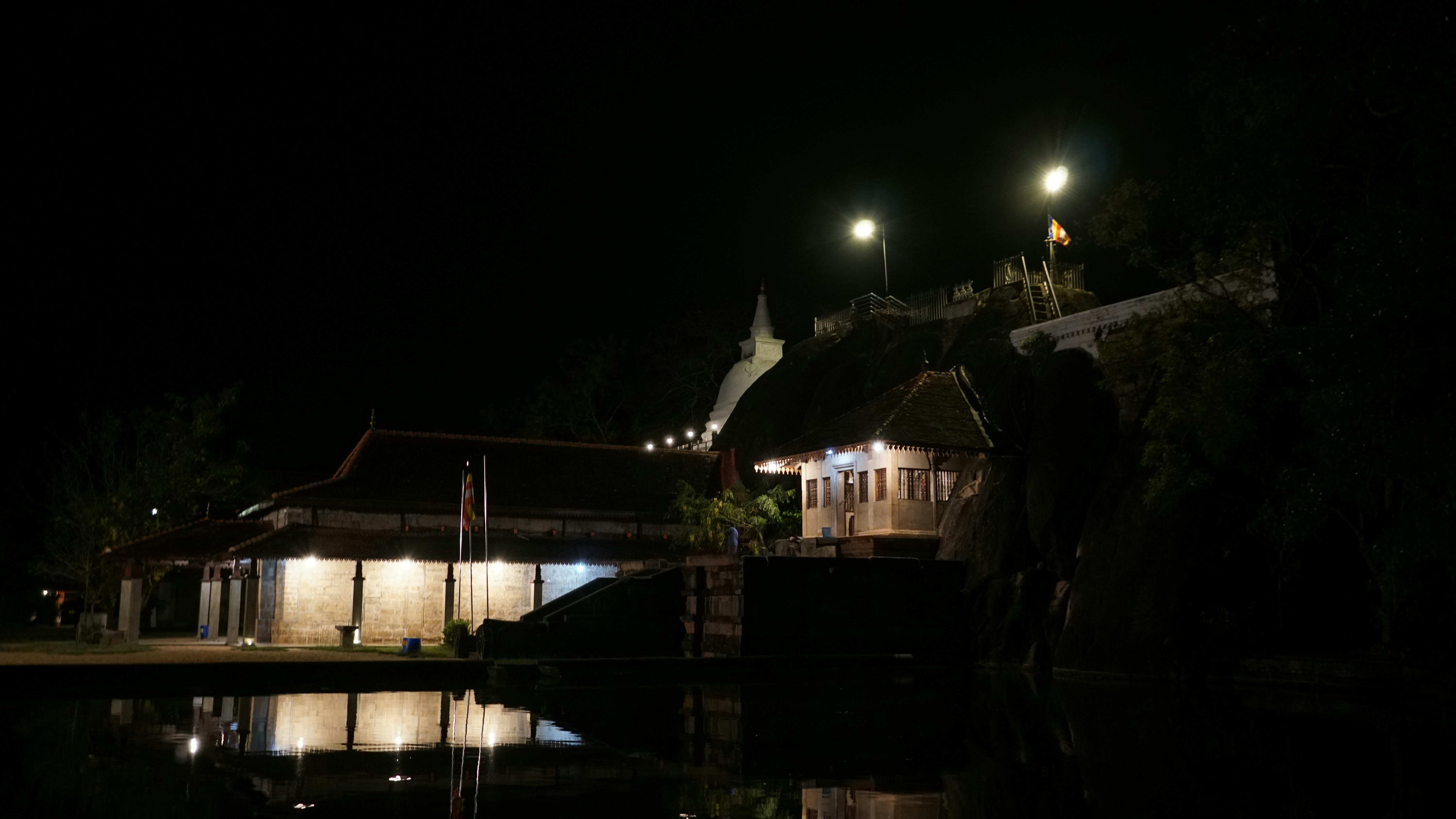 a house is lit up at night by street lights