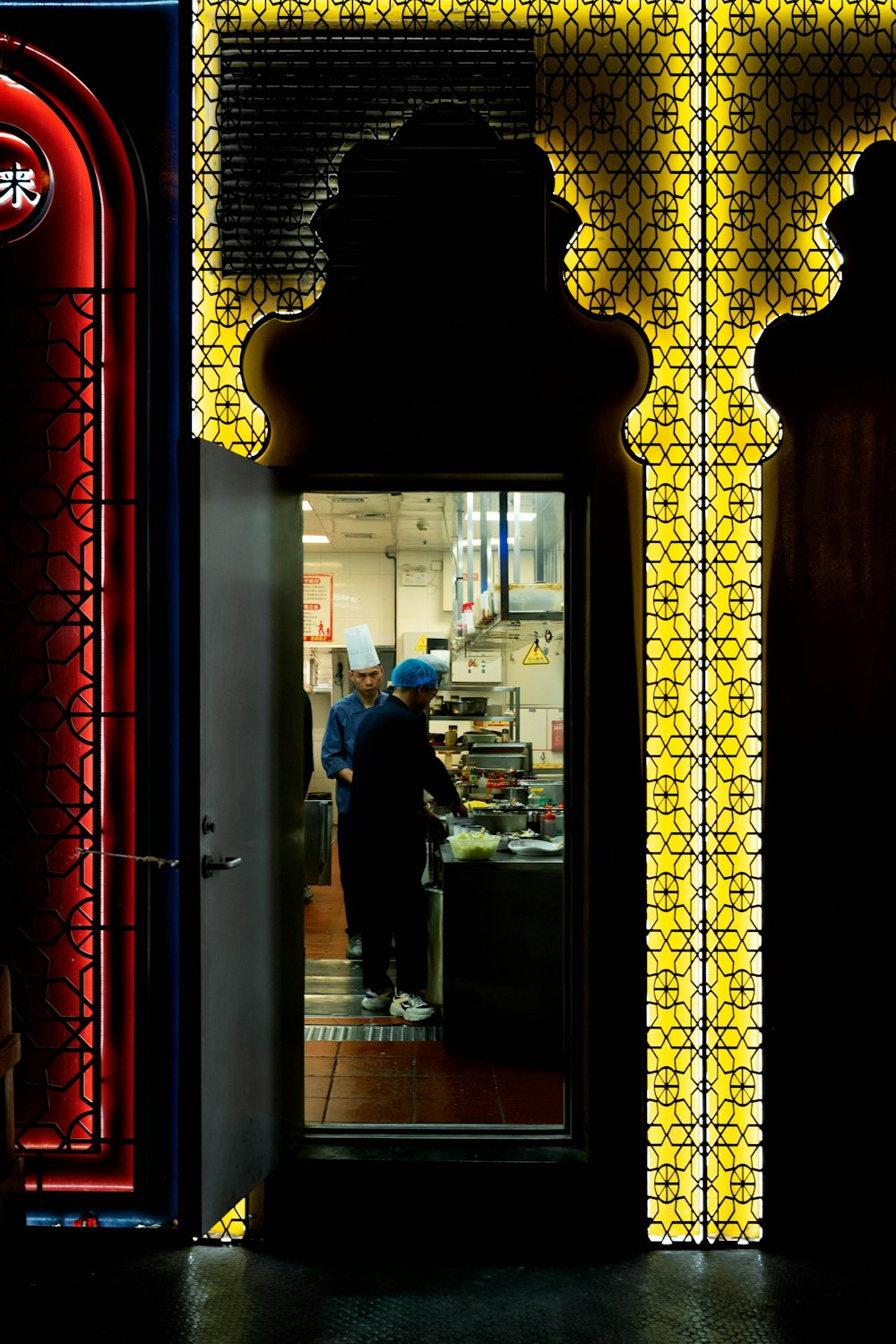 a man standing in the doorway of a restaurant