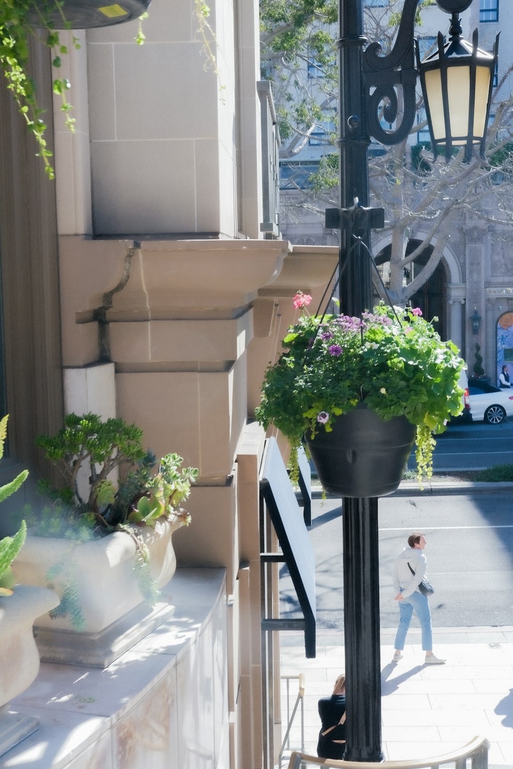 a man walking down a street next to a lamp post