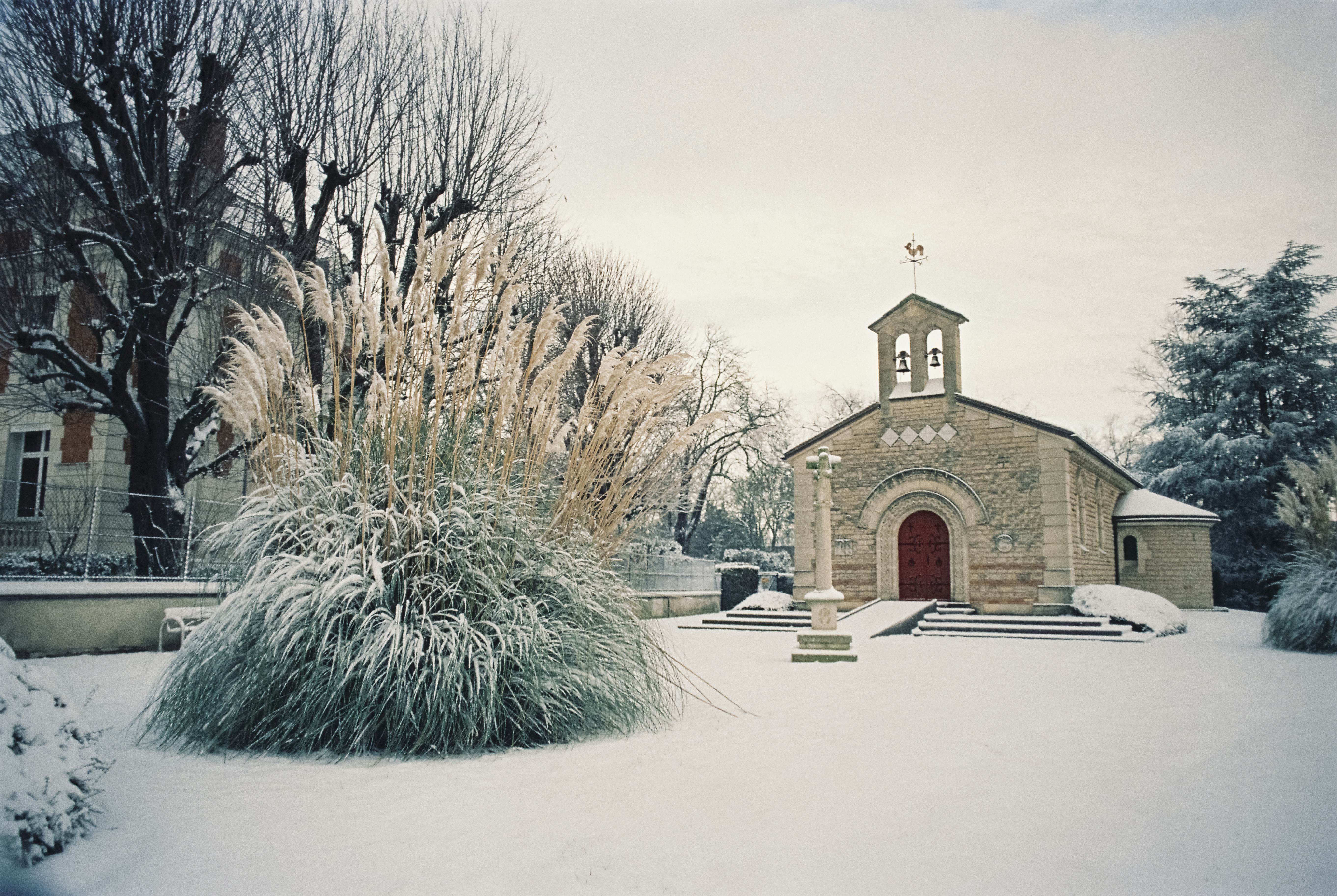 a church in the middle of a snowy field