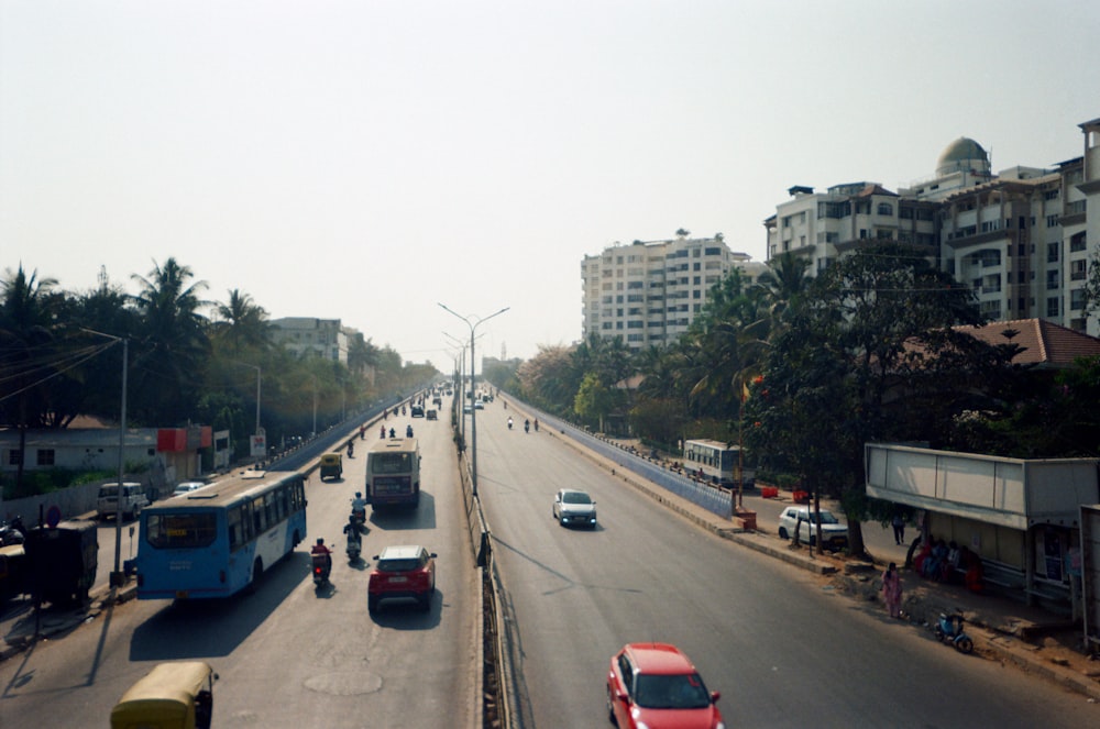 a city street filled with traffic next to tall buildings