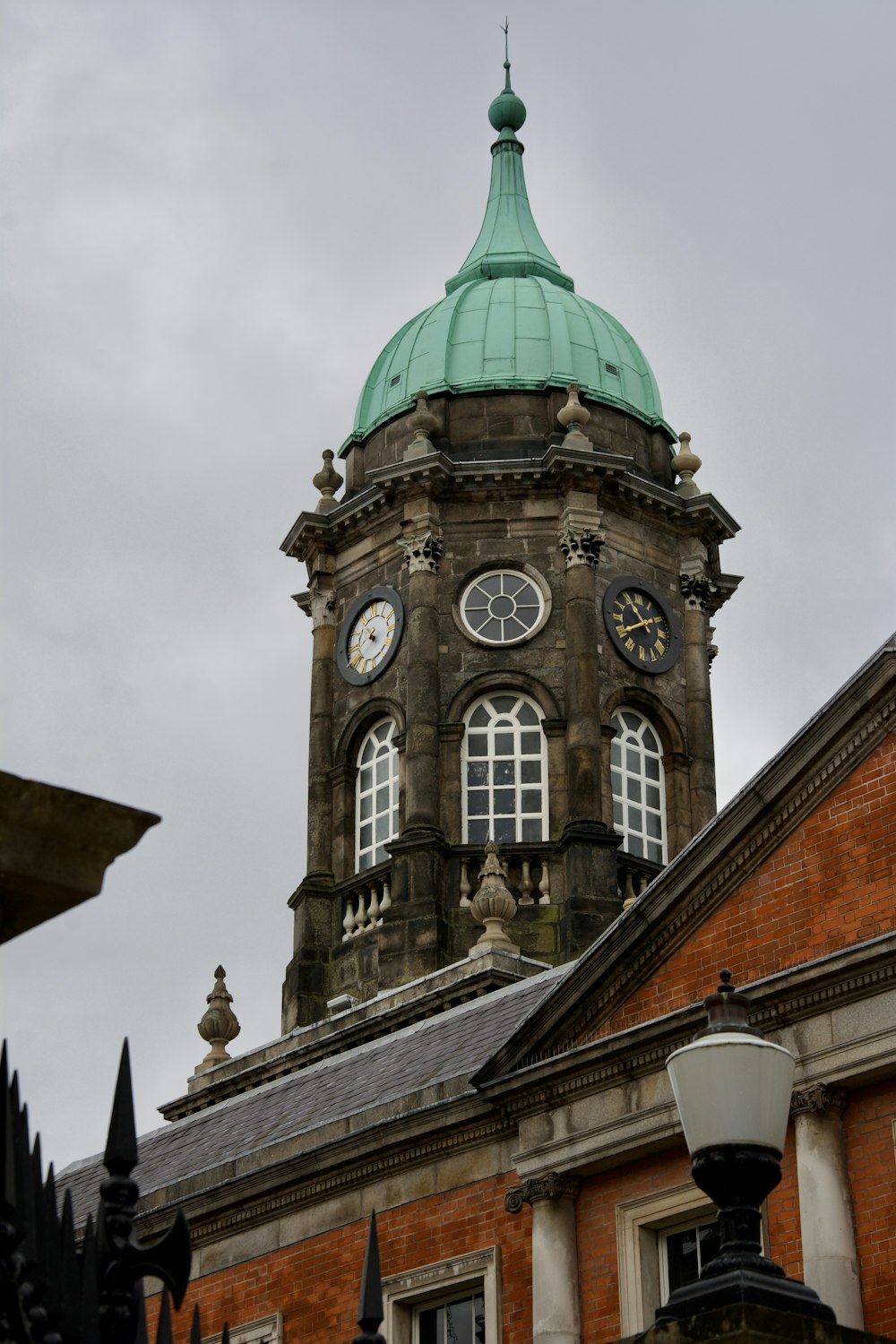 a clock tower with a green dome on top of a building