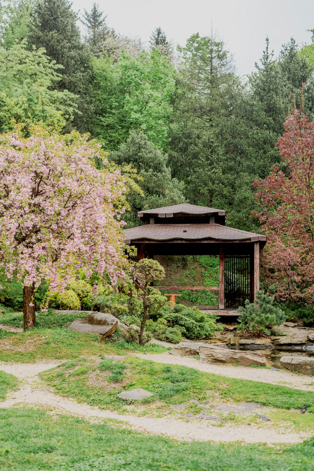 a gazebo in the middle of a lush green park