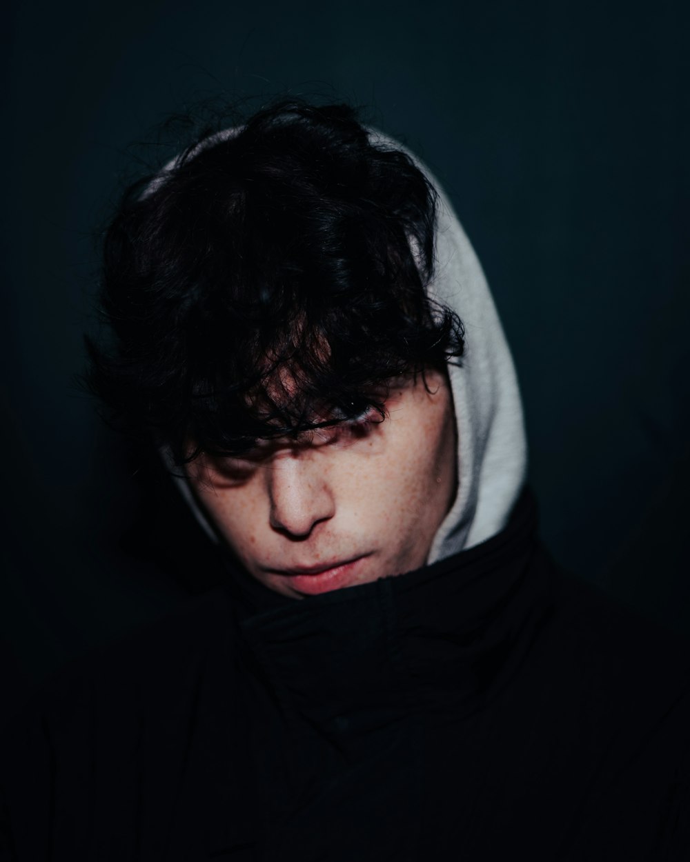 a young man with a hoodie over his head