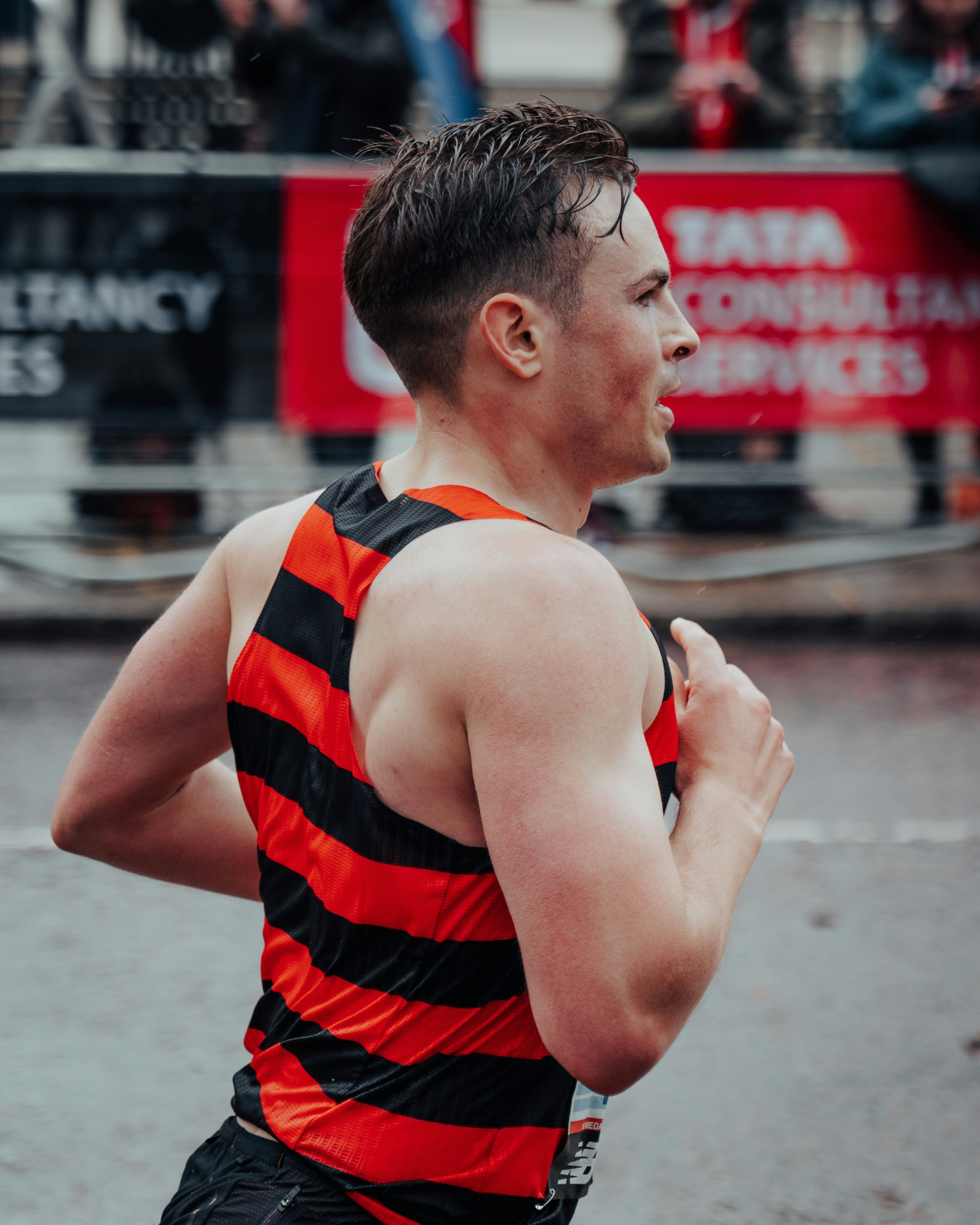a man running in a race in the rain