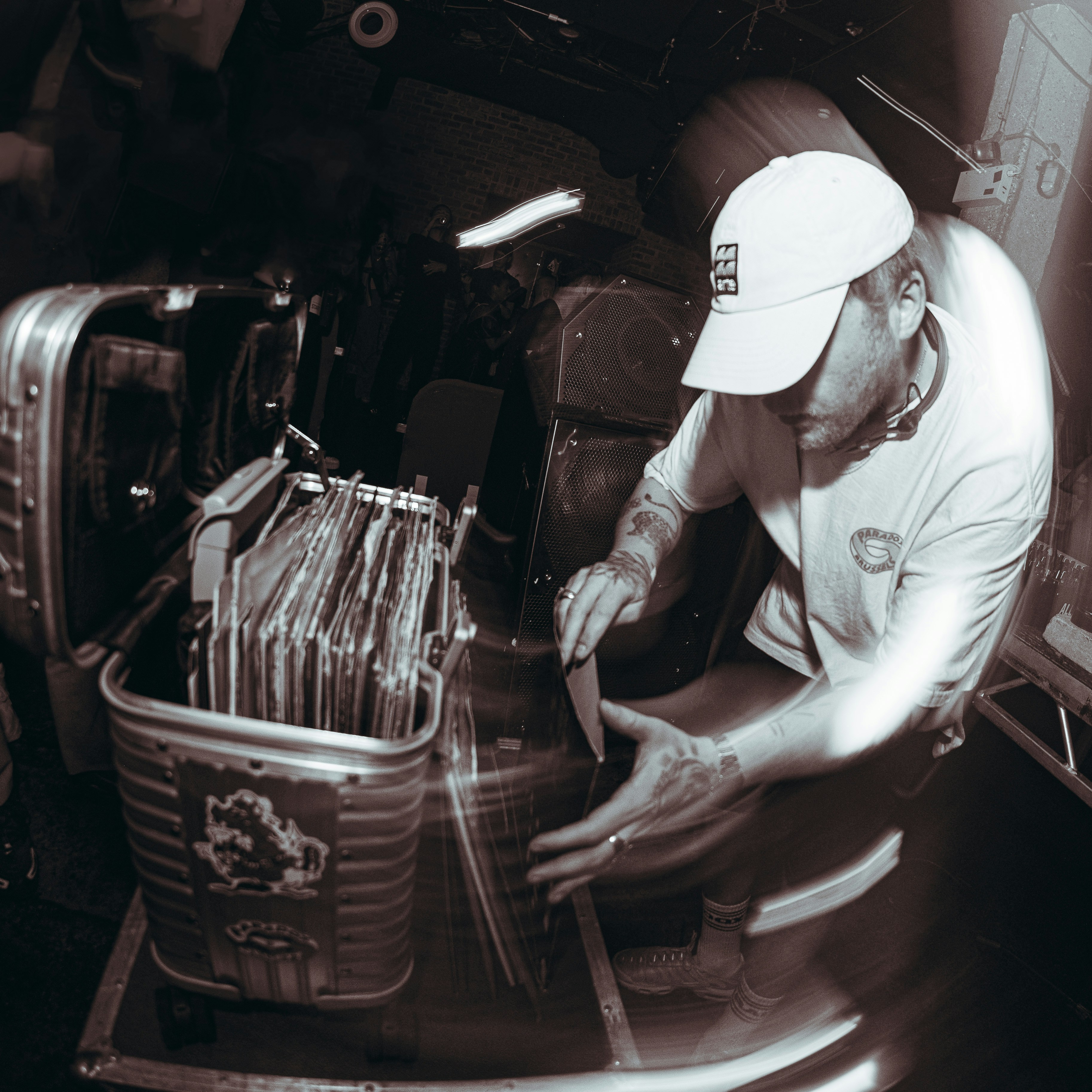 a man in a white hat is working on a piece of metal