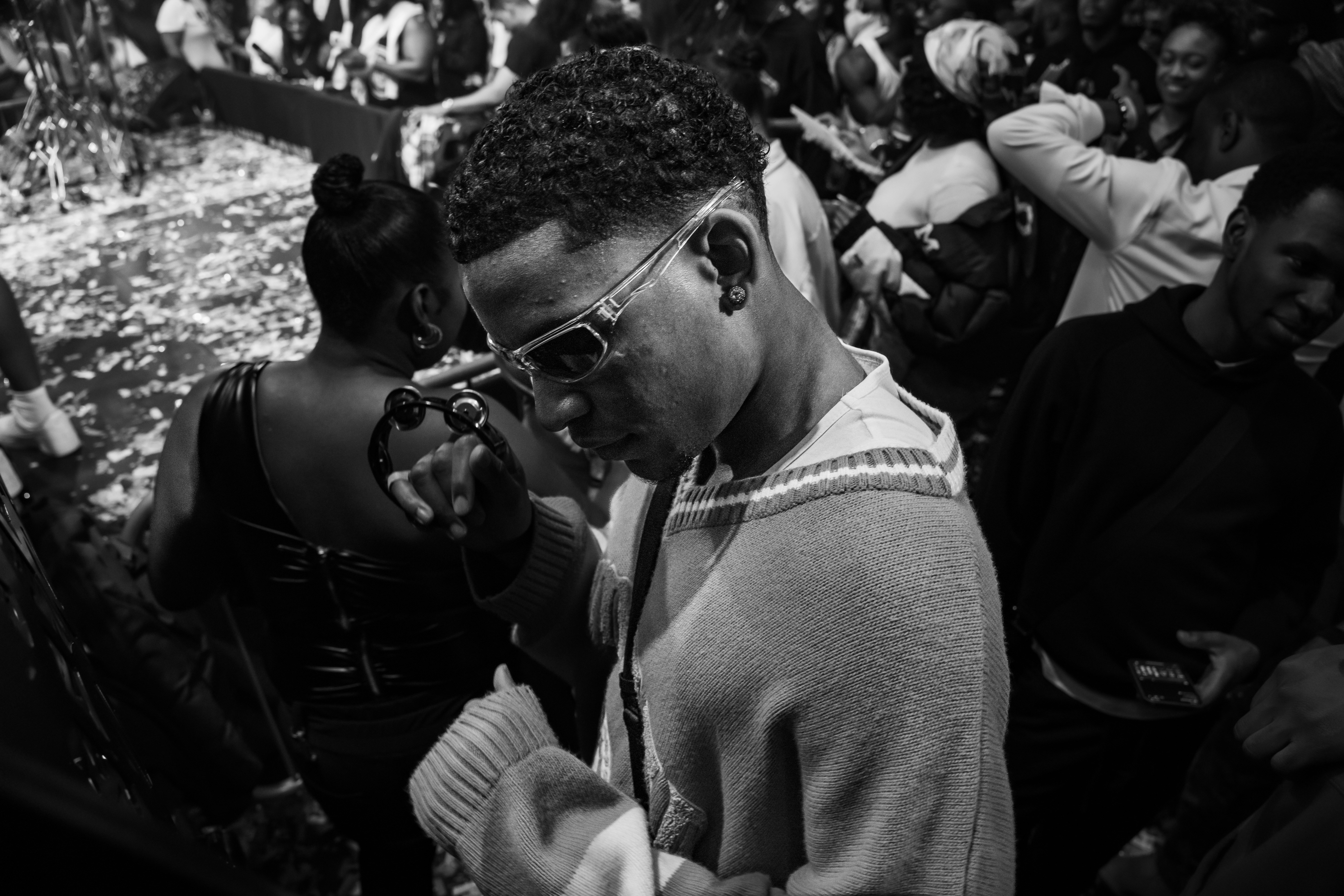 a man in a crowd looking at his cell phone