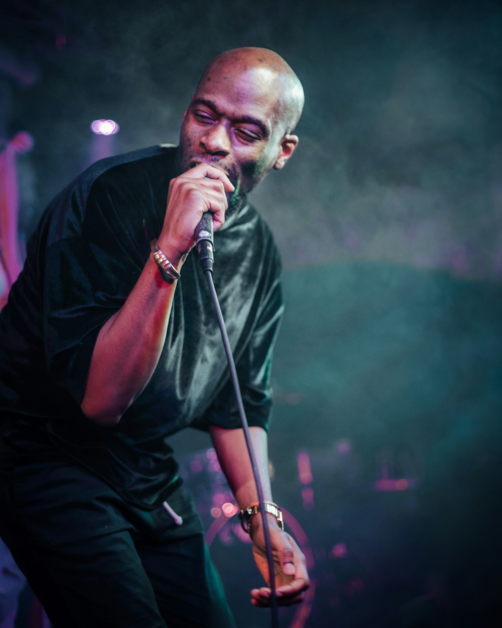 a man standing on a stage holding a microphone