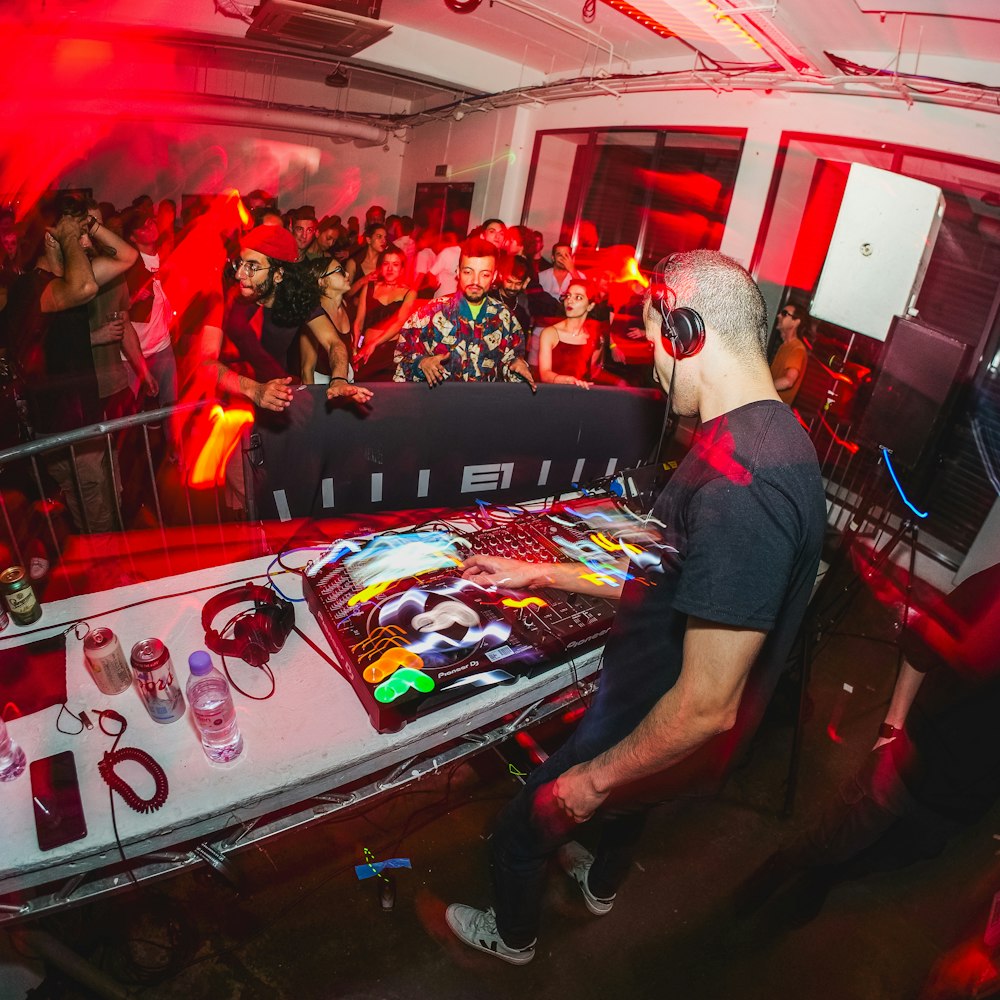 a dj mixing in front of a crowd of people