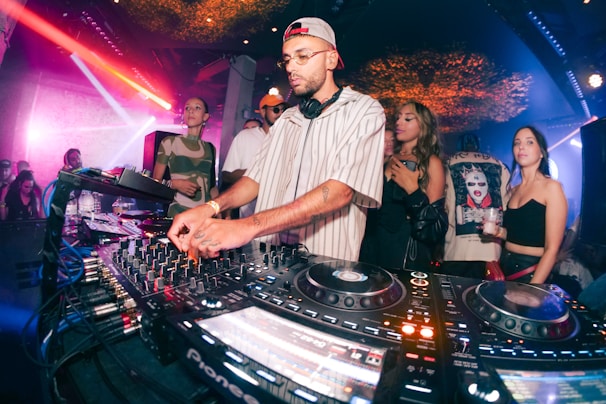 a dj mixing music in front of a crowd of people