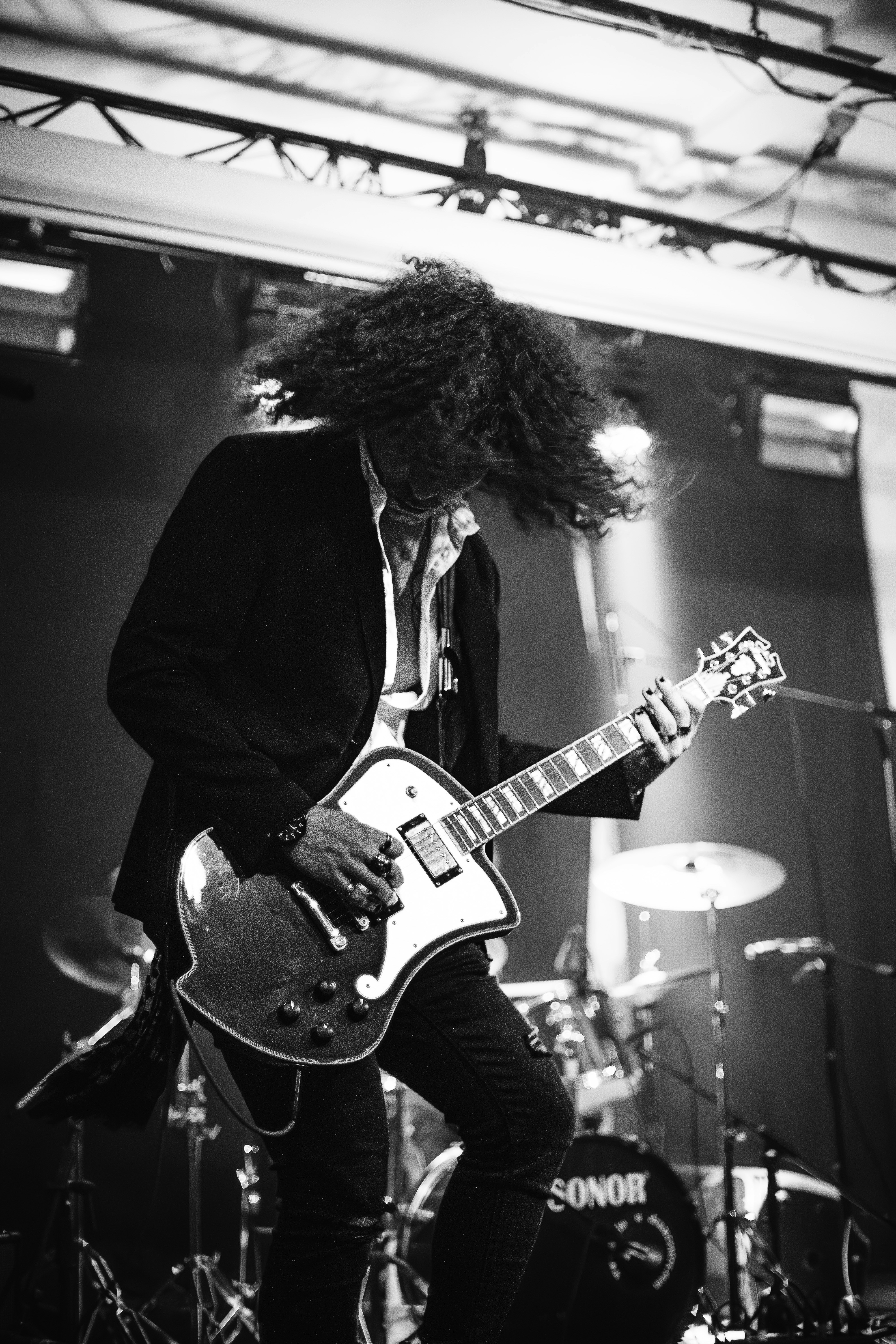 a black and white photo of a man playing a guitar