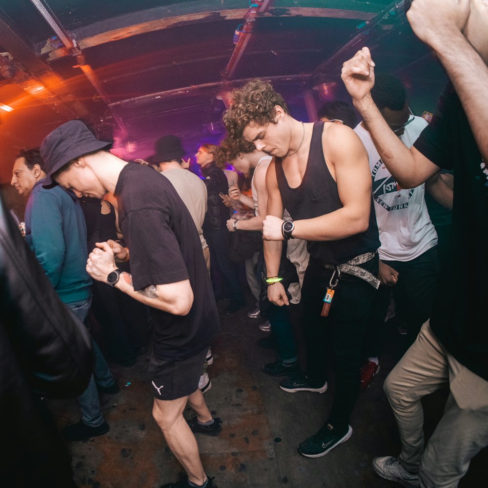 a group of young men dancing at a party