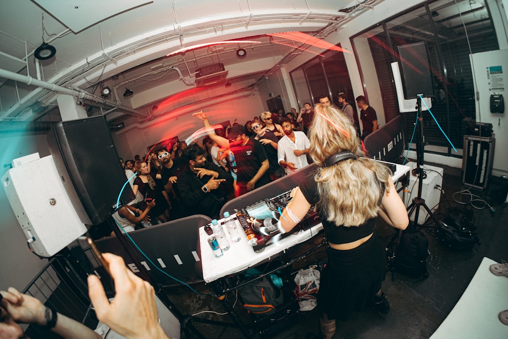 a group of people in a room with dj equipment
