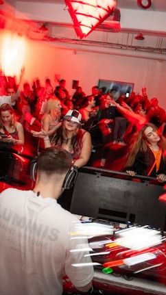 a group of people in a room with red lights