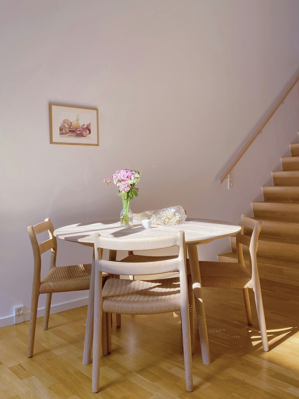 a table with a vase of flowers on top of it