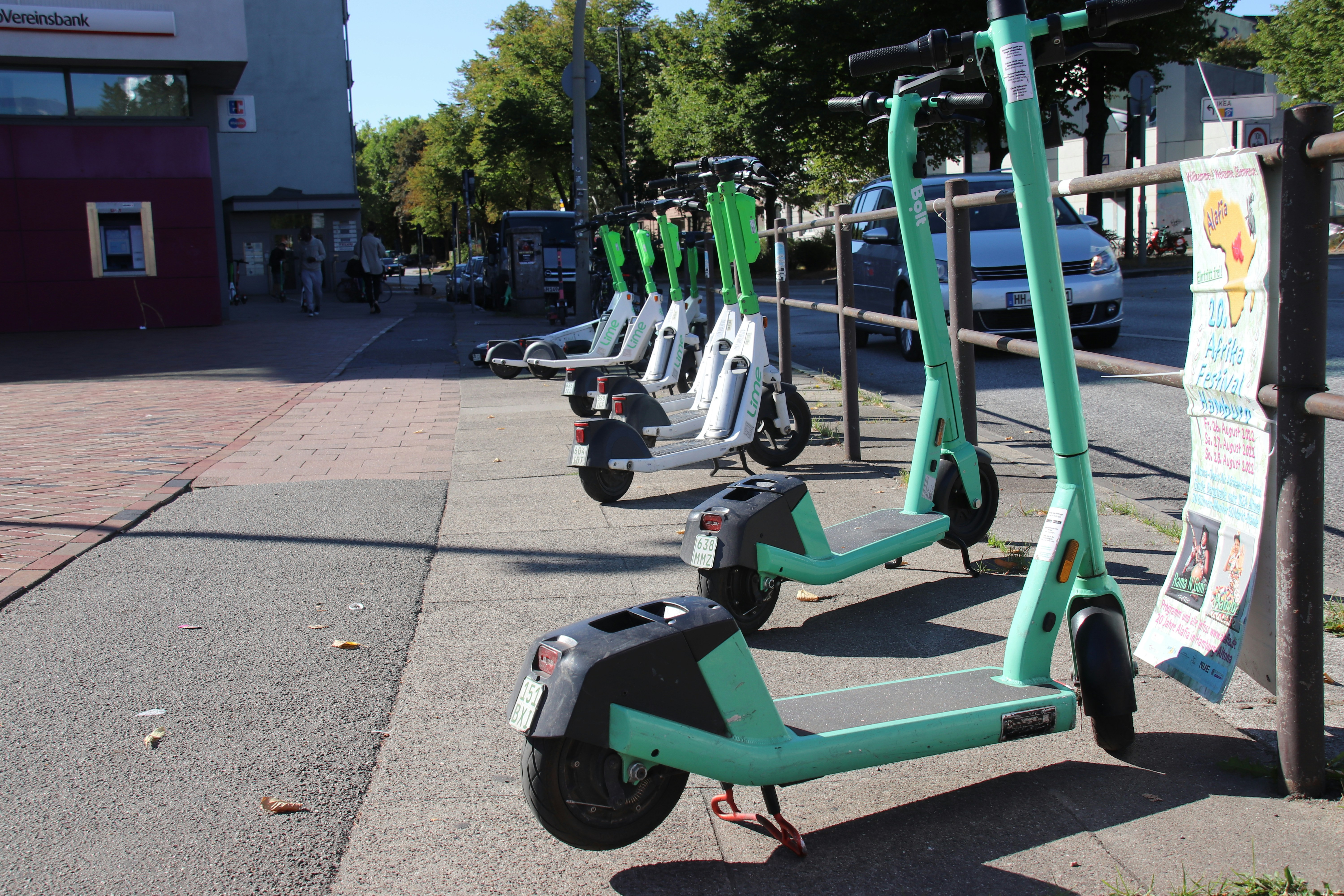 a row of scooters parked on the side of a street