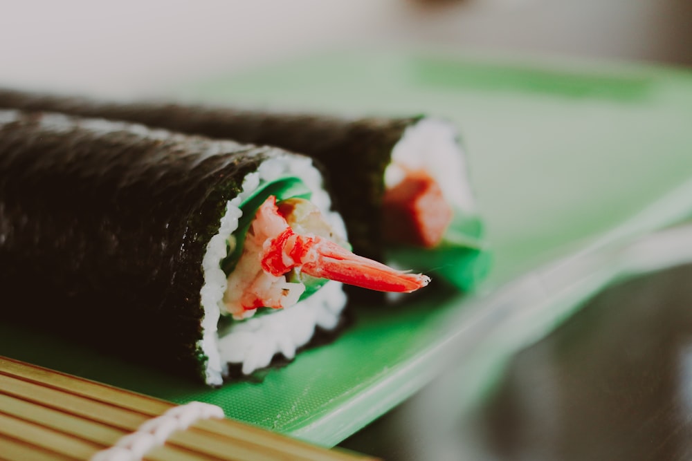 a close up of a sushi roll on a green plate