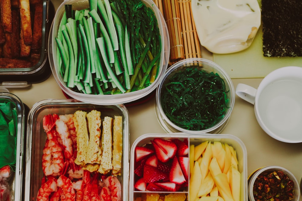 a table topped with trays of different types of food