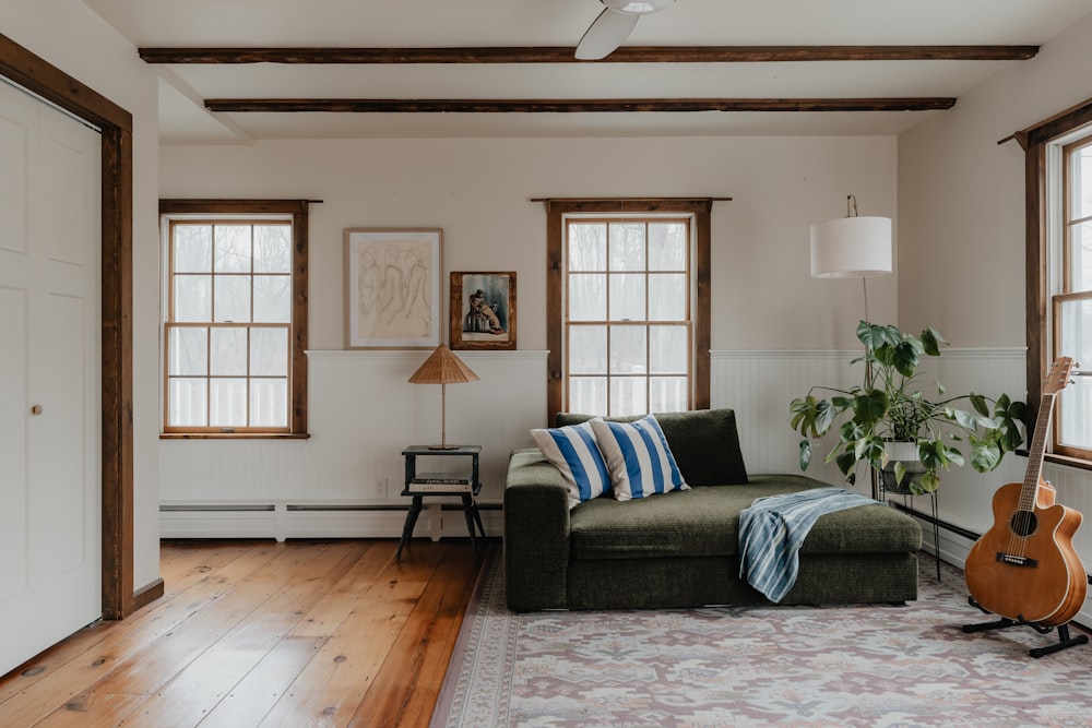 a living room with a couch and a guitar