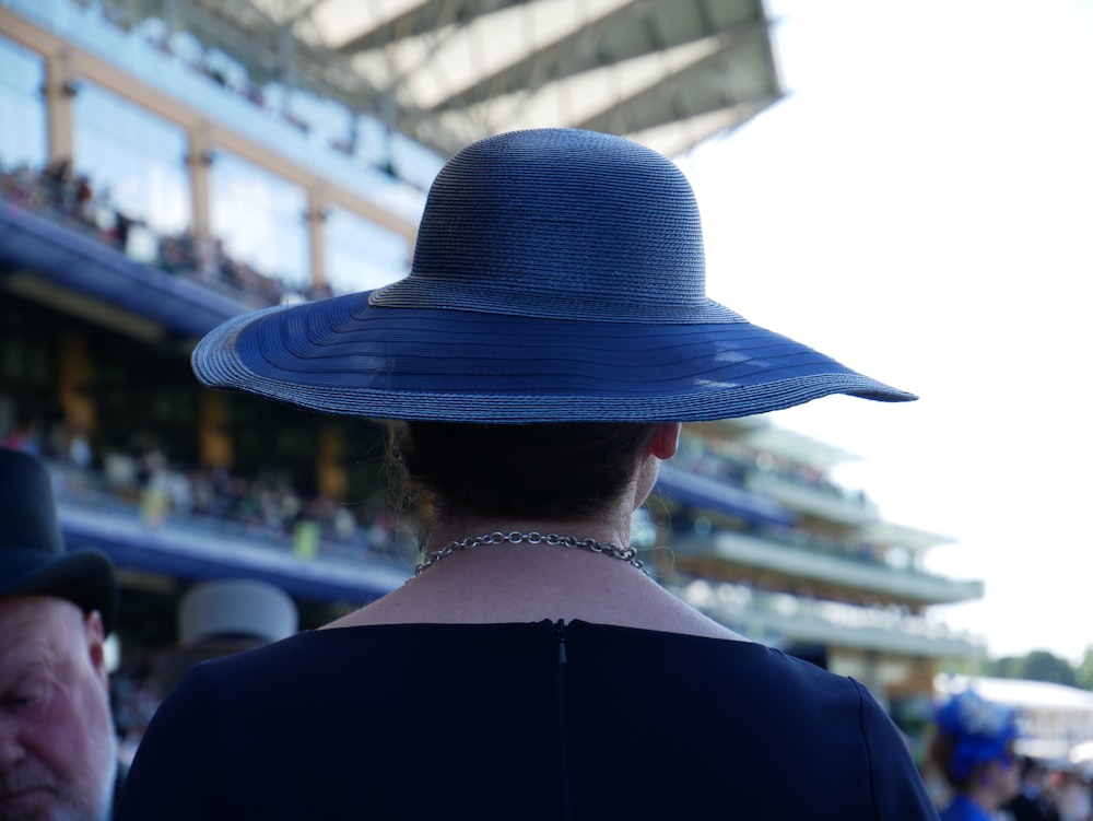 a woman wearing a blue hat at a race