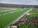 a crowd of people standing around a race track