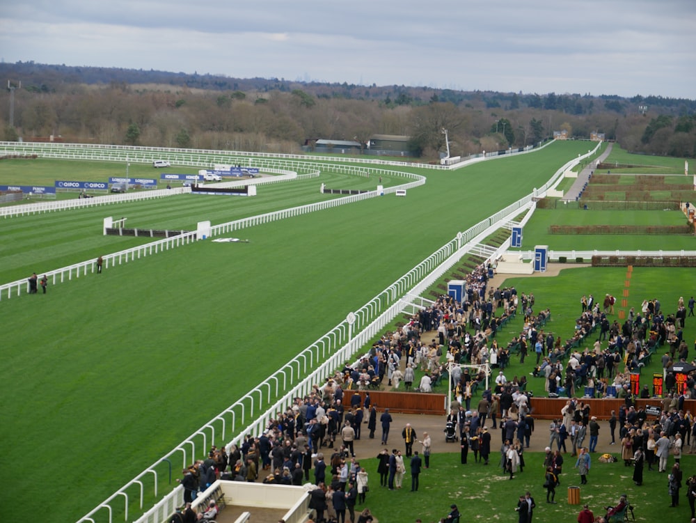 a crowd of people standing around a race track