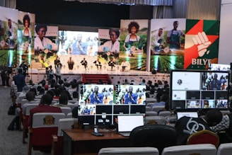 a group of people sitting in front of computer monitors